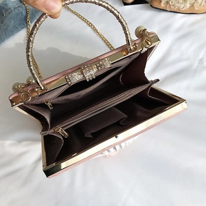 Internal view of pink box clutch bag with gold rhinestone handle and inner compartments