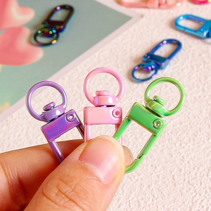 Colorful metal swivel lobster clasps for DIY jewelry and keychains shown in hand