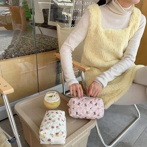 Detailed view of quilted cotton makeup bags with cute bear and flower patterns
