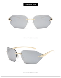 Detail view of gold metal temples and silver mirrored lenses of rimless sunglasses