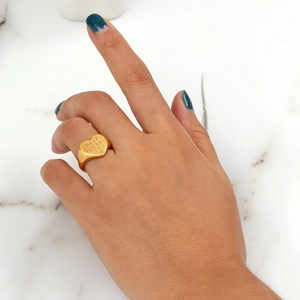 Golden heart signet ring with SELF LOVE CLUB engraving worn on model hand
