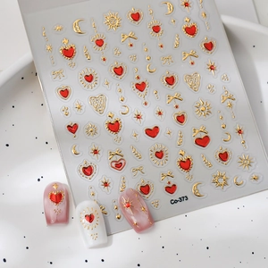 Detailed 3D embossed nail stickers featuring ruby hearts and golden celestial galaxy motifs