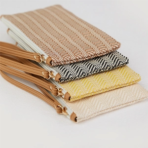 Detail of woven straw clutch bags with chevron patterns in four elegant colorways