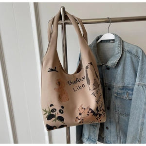 Detail of canvas tote bag featuring cute animal illustrations and high-quality fabric texture