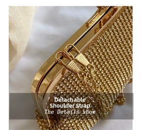 Detail of the golden clutch featuring sparkling rhinestones and a detachable chain link