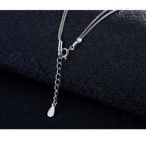 Detailed macro view of silver double-layered heart necklace with spring clasp and chain