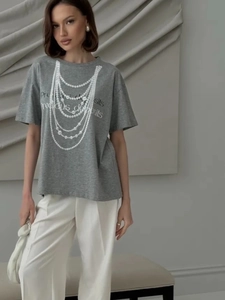 Detailed view of grey cotton T-shirt featuring a pearl necklace print and artistic text