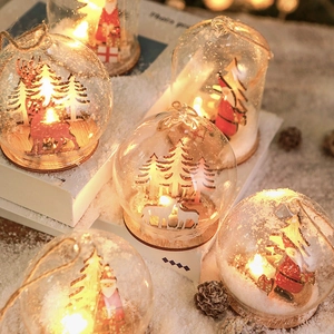 Christmas LED glass ball pendant with wooden Santa and reindeer scene in warm lighting
