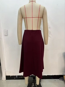 Rear view of a minimalist deep red midi skirt with knot detail on a mannequin
