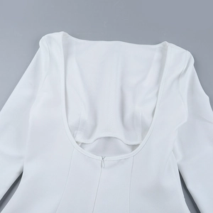 Detail of the white backless dress featuring a deep U-cut and invisible zipper closure