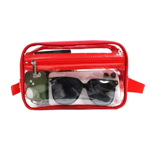 Detail of red-trimmed transparent PVC waist bag showing clear capacity and red adjustable strap