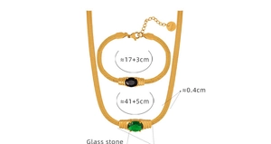 Detail view of gold snake chain set with green and black oval glass stones and size specs