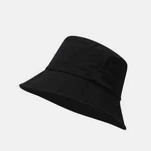 Detailed view of black bucket hat featuring a flat top design and reinforced brim stitching
