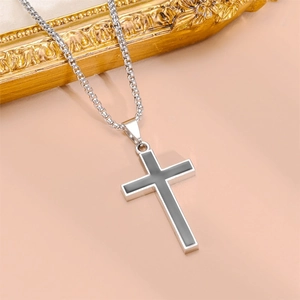 Silver stainless steel cross pendant necklace with box chain on elegant background