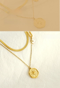 Close-up of gold double-layer necklace with hexagram coin pendant and snake chain detail