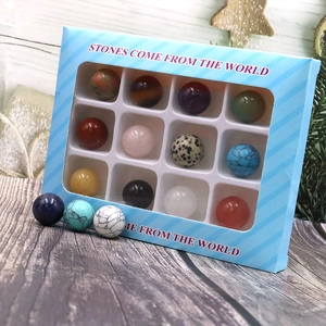 Detailed gift box featuring twelve assorted natural semi-precious stone spheres on wood