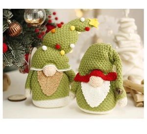 Close-up of knit Christmas gnome figures with textured fabric and soft holiday background