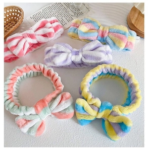 Macro detail of soft coral fleece headbands in colorful pastel stripes for skincare