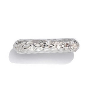 Detail of silver rectangle hair cuff with handmade hammered texture on metal surface