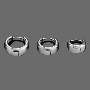 Polished stainless steel twist earrings set in three sizes on a dark background