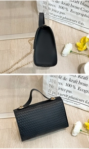 Vista detallada del bolso de cadena negro grabado con herrajes dorados y textura tejida