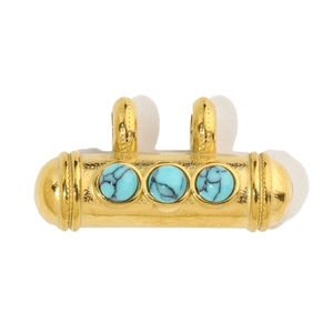 Detail of a vintage gold titanium steel pendant set with three natural turquoise stones