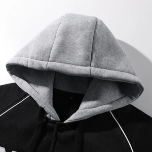 Close-up of contrast grey knit hood with black drawstrings and white shoulder piping details