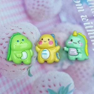 Close-up of colorful cute resin dinosaur charms for DIY phone case and hair clip crafts
