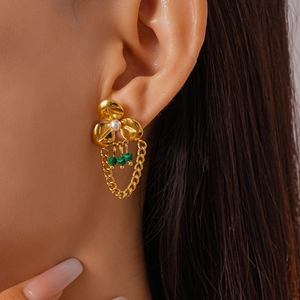Close-up of vintage flower earrings with pearl and malachite bead fringe tassels