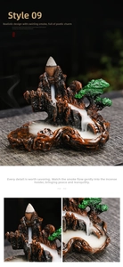 Detailed macro view of zen backflow incense burner with mountain landscape and waterfall smoke