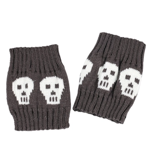 Close-up of knit ankle warmers featuring a white skull pattern on dark grey fabric