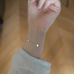 Elegant gold-plated titanium steel bracelet featuring a minimalist heart shape pendant for women