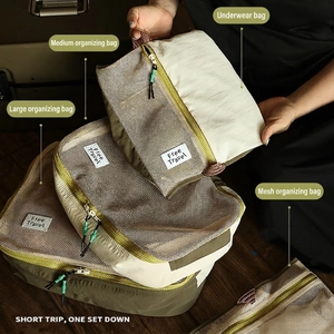 Nylon travel organizer set with beige and olive green packing cubes for luggage