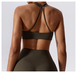Close-up of olive green yoga sports bra with criss-cross back straps and high-waist leggings