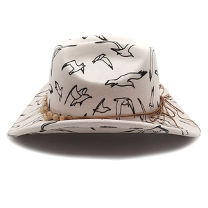 Detail view of cream camouflage fedora with seagull prints and beaded brown cord strap