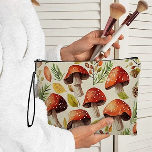 Canvas makeup bag with mushroom botanical print and convenient black wristlet strap