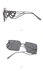 Detail view of dark grey frameless square sunglasses with hollow heart-shaped temples