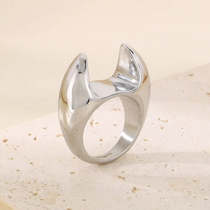 Macro detail of silver stainless steel ring with chunky curved design on stone