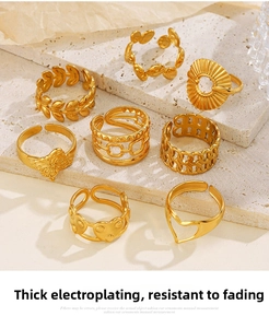 Detail view of gold-plated stainless steel ring set with heart and butterfly designs