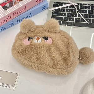 Close-up of cute plush animal pouch with embroidery detail and soft pom-pom zipper