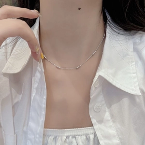 Minimalist S925 sterling silver beaded chain necklace worn on neck over a white shirt