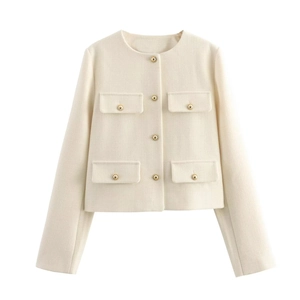 Detail of ivory tweed jacket with gold buttons and four flap pockets on white background