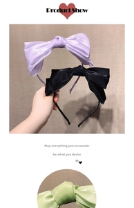 Detail of elegant satin bow headbands in purple, black, and light green colors