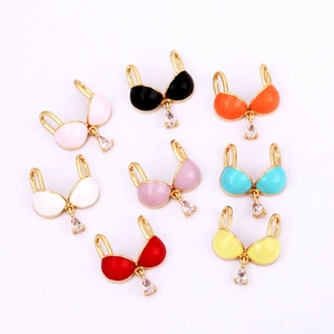 Detailed view of colorful enamel brass bra charms with sparkling cubic zirconia stones