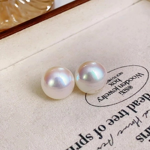 Macro shot of high-luster white round pearls with rainbow iridescence on canvas