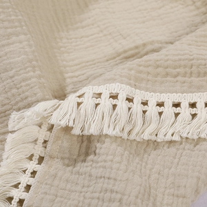 Soft double-layer cotton gauze baby blanket with decorative tassel fringe in beige