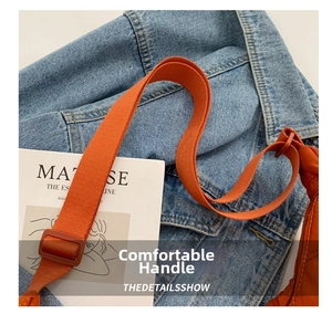 Detail of adjustable bright orange nylon strap with durable buckle on a casual tote bag