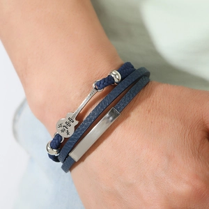Close-up of blue braided leather multi-layer bracelet with silver guitar charm for men