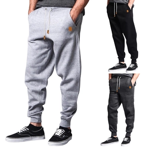 Detail view of men's casual joggers in light grey, dark grey, and black colors