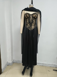 Detail of black lace corset dress with sheer bodice and matching mesh shawl wrap